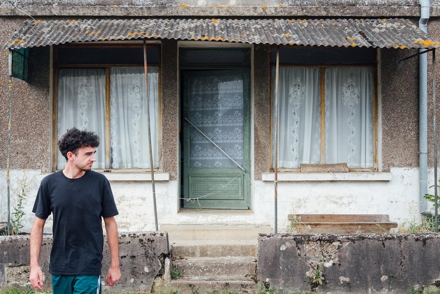 Squatter walking out of dilapidated home he is unlawfully occupying in violation of NRS 205.0817.