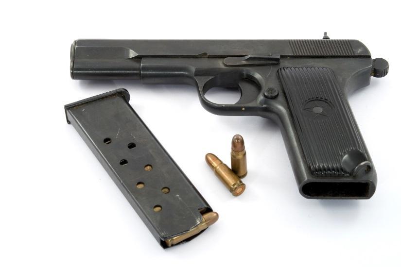 Firearm with bullets against white backcground