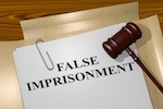 gavel over a file that reads "false imprisonment"