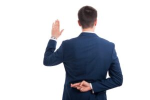 Man taking oath while crossing fingers