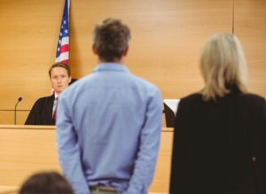 Court reprimanding defendant (standing next to defense attorney) for missing court
